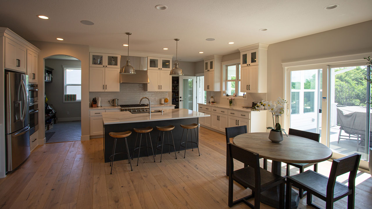 A modern remodeled kitchen with updated cabinetry, countertops, and lighting.