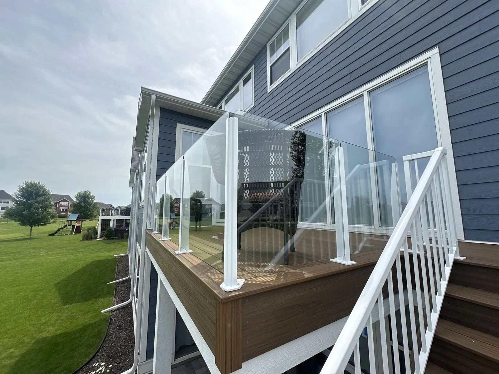 Elevated deck with white railings built by BN Builders