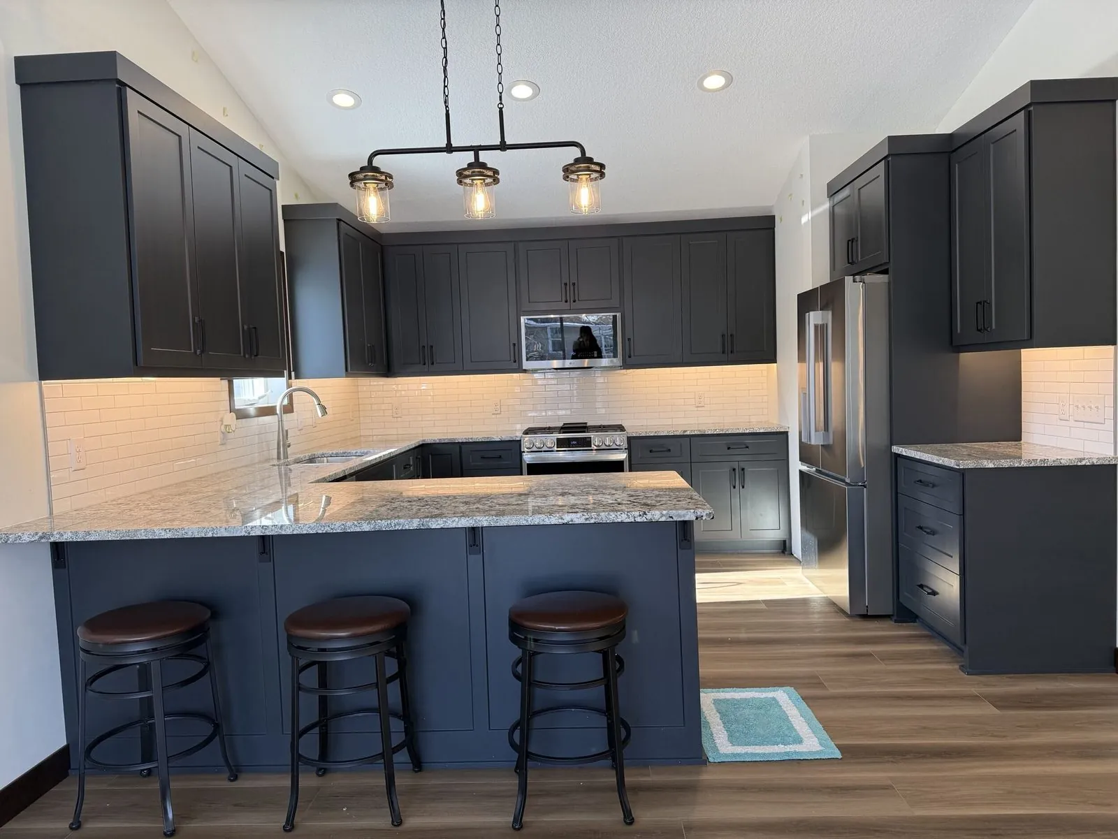 Remodelled kitchen with island seating, Northfield MN by BN Builders